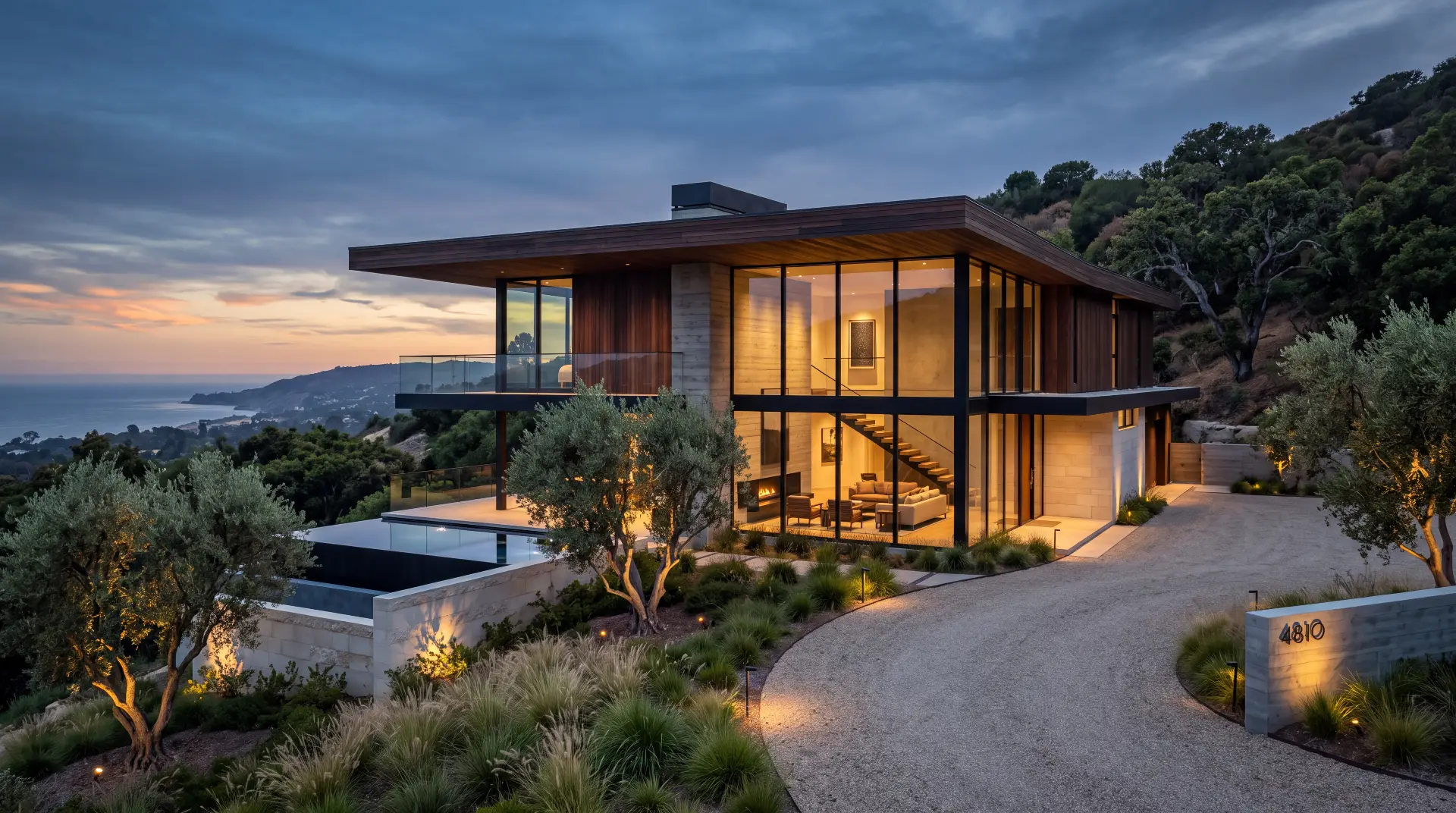 Completed hillside villa in California seen across its terrace at dusk